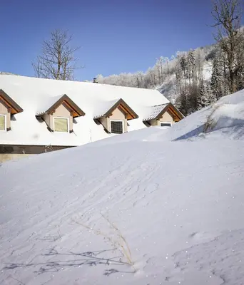a pile of snow in front of a house at TDI - Modern 2-Bedroom Apartment in nature