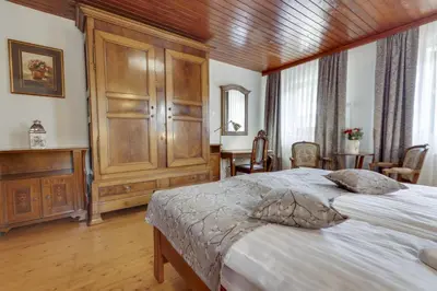 a bedroom with a large bed and a wooden ceiling at Lake Bled Holiday Home in Bled