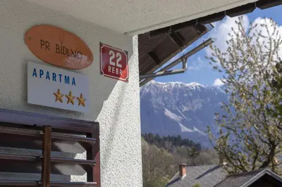 a sign on a building with a view of a mountain at Lake Bled Holiday Home in Bled