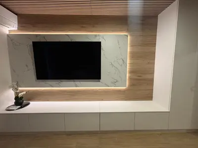 a flat screen tv on a wall in a room at Apartman O Terme Olimia in Ravne na Koroškem