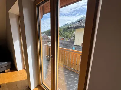a sliding glass door with a view of a balcony at Apartment Kranjska Gora Diamond in Kranjska Gora