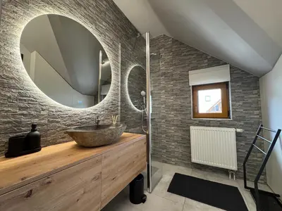 a bathroom with a sink and a mirror at Apartment Kranjska Gora Diamond in Kranjska Gora