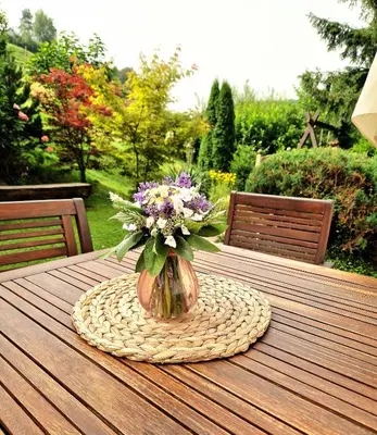 a vase of flowers sitting on top of a table at Atelje Mlin Umetnin Retreat in Šentjur