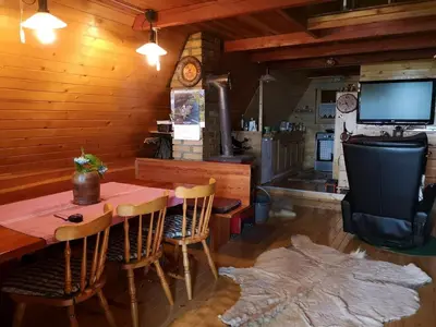 a dining room with a table and chairs and a television at The house at the larssen in Šmartno pri Slovenj Gradcu
