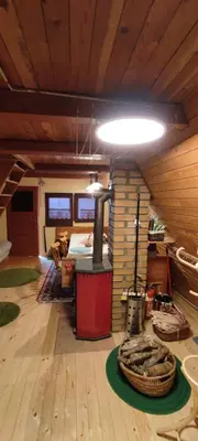 a living room with a woodburning stove in a room at The house at the larssen in Šmartno pri Slovenj Gradcu