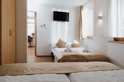 a hotel room with two beds and a couch at Gostišče Iršič in Slovenska Bistrica
