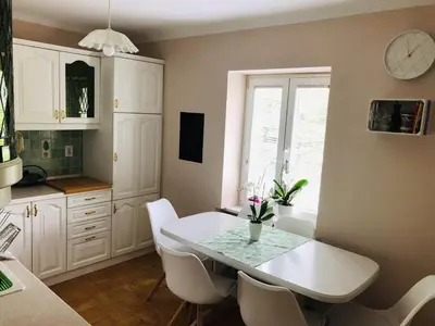 a kitchen with a white table and white chairs at Apartma center in Rogaška Slatina