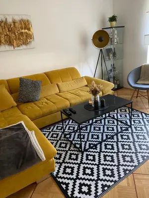 a living room with a yellow couch and a table at Apartma center in Rogaška Slatina
