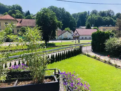 a garden with purple flowers and a fence at Apartma center in Rogaška Slatina