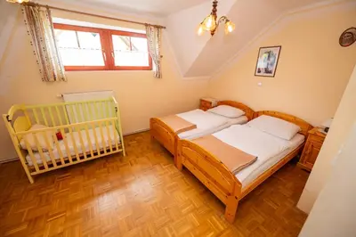 a bedroom with a bed and a baby crib at Winery Toplak in Juršinci