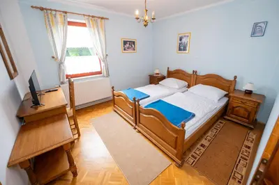 a bedroom with a wooden bed and a piano at Winery Toplak in Juršinci