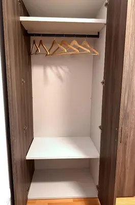 a closet with wooden shelves and hangers at RailwayRooms22 in Ljubljana