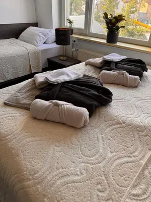 two beds with towels on top of them in a bedroom at RailwayRooms22 in Ljubljana