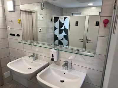 a bathroom with two sinks and a mirror at RailwayRooms22 in Ljubljana