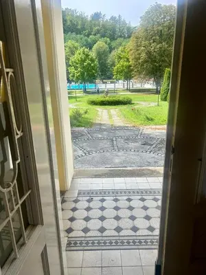 an open door with a view of a park at Ana Marija Apartment - Vila Golf in Rogaška Slatina
