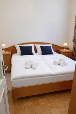 a bedroom with a large bed with two towels on it at Ana Marija Apartment - Vila Golf in Rogaška Slatina