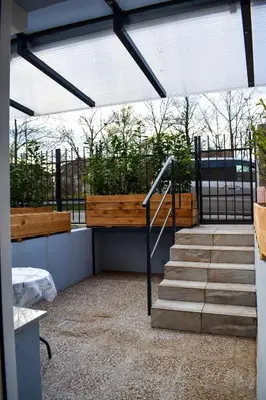 a balcony with a wooden bench and stairs at Apartment River Ljubljanica in Ljubljana