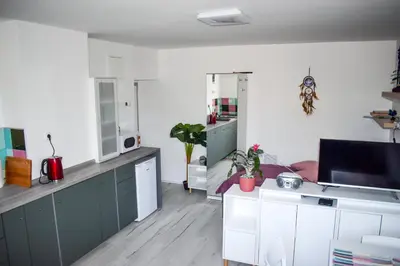 a kitchen with white walls and green cabinets at Apartment River Ljubljanica in Ljubljana