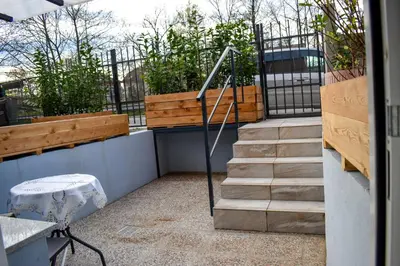 a set of stairs leading to a balcony with plants at Apartment River Ljubljanica in Ljubljana