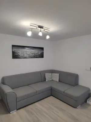 a living room with a couch in a white room at Modern appartement with big terrace in Ljubljana in Ljubljana