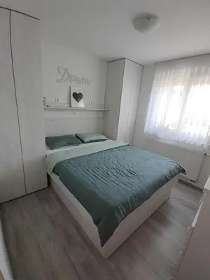 a bedroom with a bed with a green comforter at Modern appartement with big terrace in Ljubljana in Ljubljana