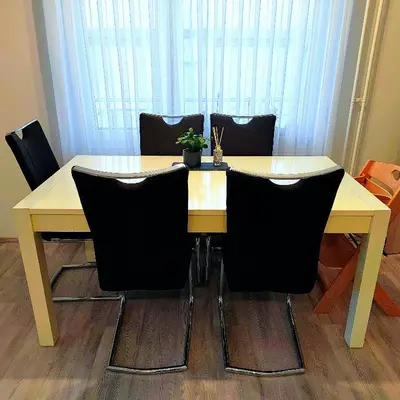 a dining room table with black chairs around it at Modern appartement with big terrace in Ljubljana in Ljubljana