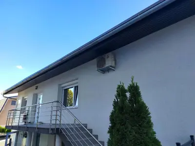 a white building with a balcony and a window at Modern appartement with big terrace in Ljubljana in Ljubljana