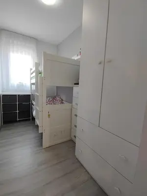 a white room with white cabinets and a bed at Modern appartement with big terrace in Ljubljana in Ljubljana