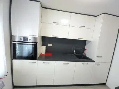 a kitchen with white cabinets and a sink at Modern appartement with big terrace in Ljubljana in Ljubljana
