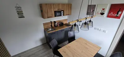 a small kitchen with a small table and a counter at Kajžarka in Miklavž pri Ormožu