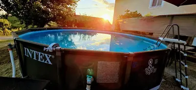 a hot tub in a yard with the sun setting at Kajžarka in Miklavž pri Ormožu