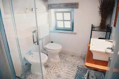 a bathroom with a toilet and a sink at Lavandula House in Štanjel