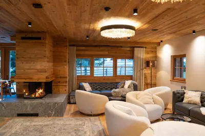 a living room filled with furniture and a fireplace at Jakobs Lodge in Zgornje Gorje