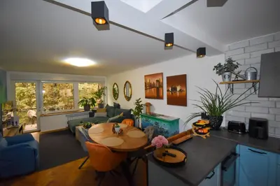 a living room with a table and a couch at Apartma Karakter in Maribor