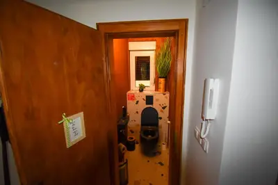 a door leading into a room with a refrigerator at Apartma Karakter in Maribor