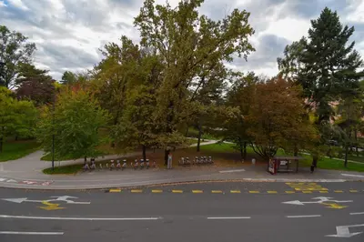 a parking lot with tables and chairs in a park at Apartma Karakter in Maribor