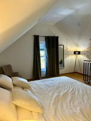 a large white bed in a room with a window at Apartma La Vie in Kostanjevica na Krki