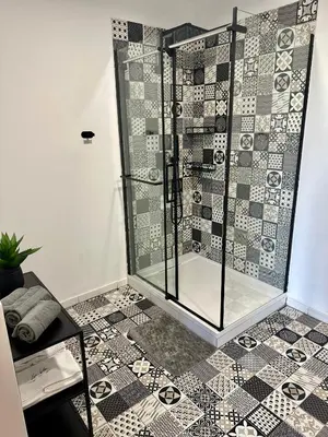 a bathroom with a shower with a tiled floor at Apartma La Vie in Kostanjevica na Krki