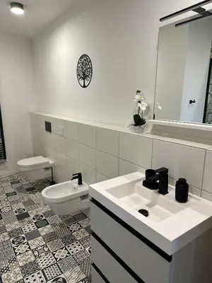 a white bathroom with a sink and a toilet at Apartma La Vie in Kostanjevica na Krki