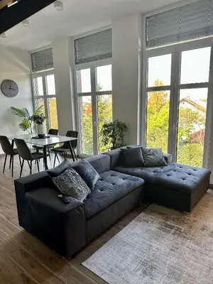 a living room with a couch and a table at Apartma La Vie in Kostanjevica na Krki