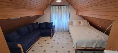 a small room with a couch and a bed at Apartment-Koželj in Dobrna