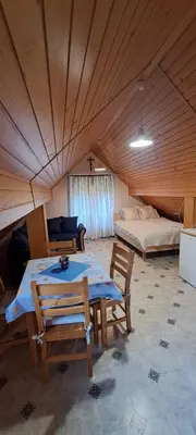 a room with a table and chairs and a bed at Apartment-Koželj in Dobrna