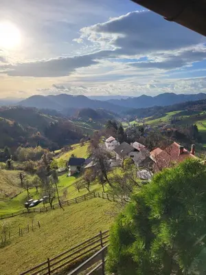 a view of a farm with mountains in the distance at Apartment-Koželj in Dobrna