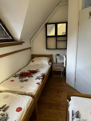 a small bedroom with two beds in a attic at Melisa's Holiday Home in Mostec