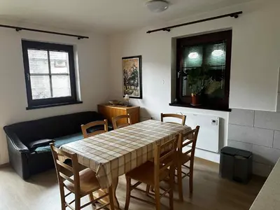 a living room with a table and chairs and a couch at Melisa's Holiday Home in Mostec