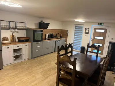 a kitchen with a wooden table and a dining room at Prista Ranch Cirkulane in Rove