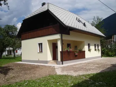 a small house with a black roof at Apartment Veduta in Bovec