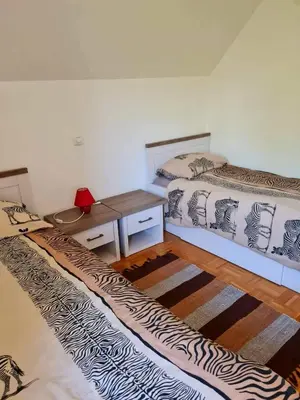 a room with two beds and a desk in it at Apartment Veduta in Bovec