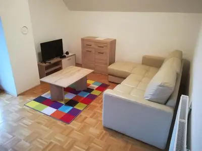 a living room with a couch and a table at Apartment Veduta in Bovec