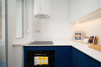 a kitchen with blue cabinets and a sink at Petka apartments in Ljubljana